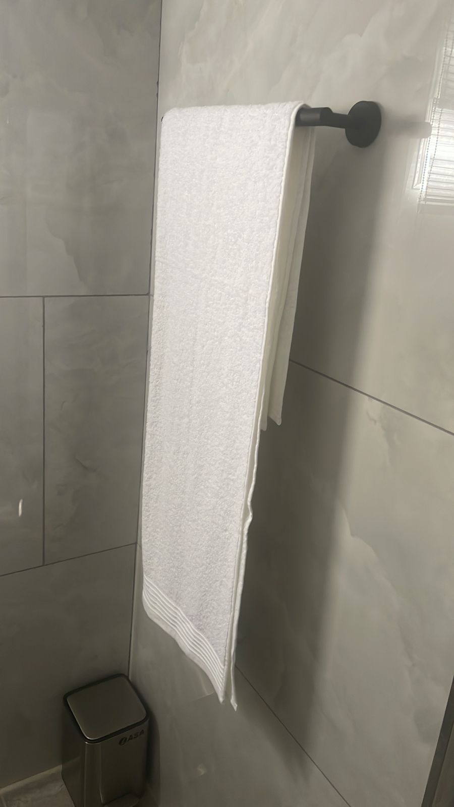 Bathroom shelf with towel and amenities