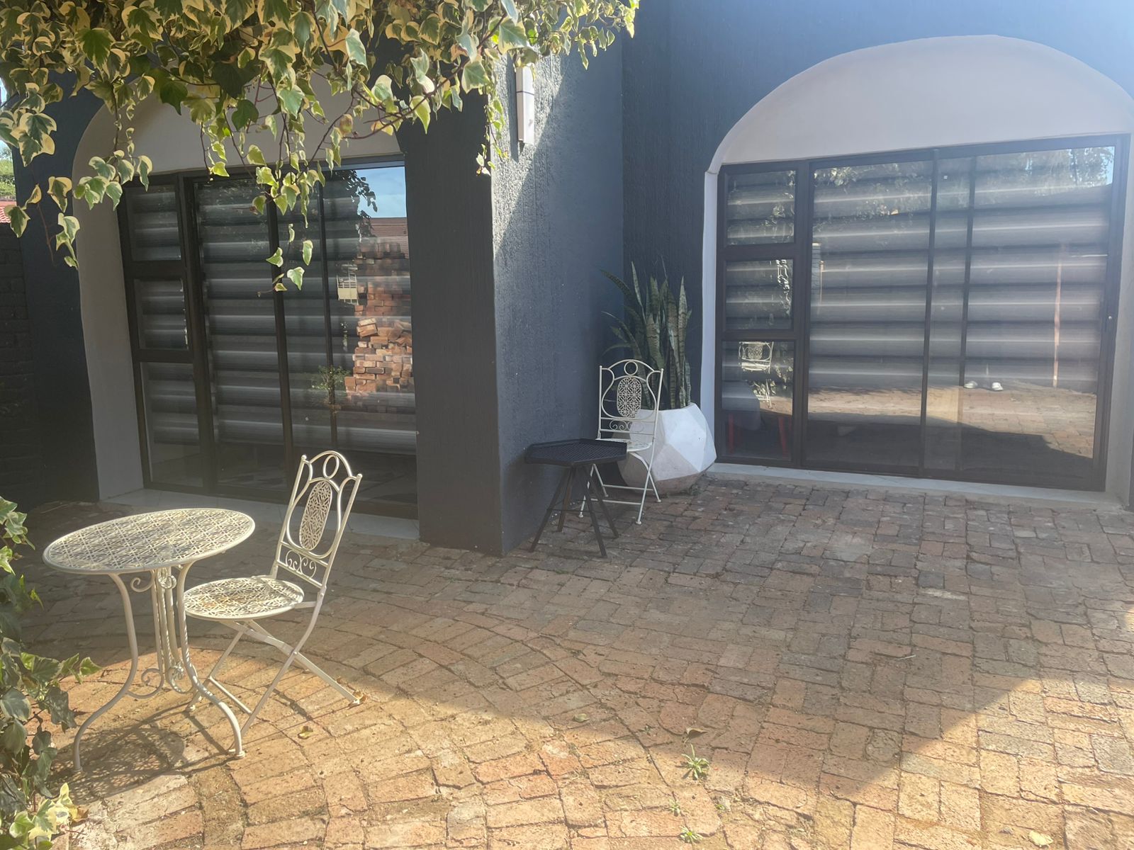 Private patio with arched windows and ivy