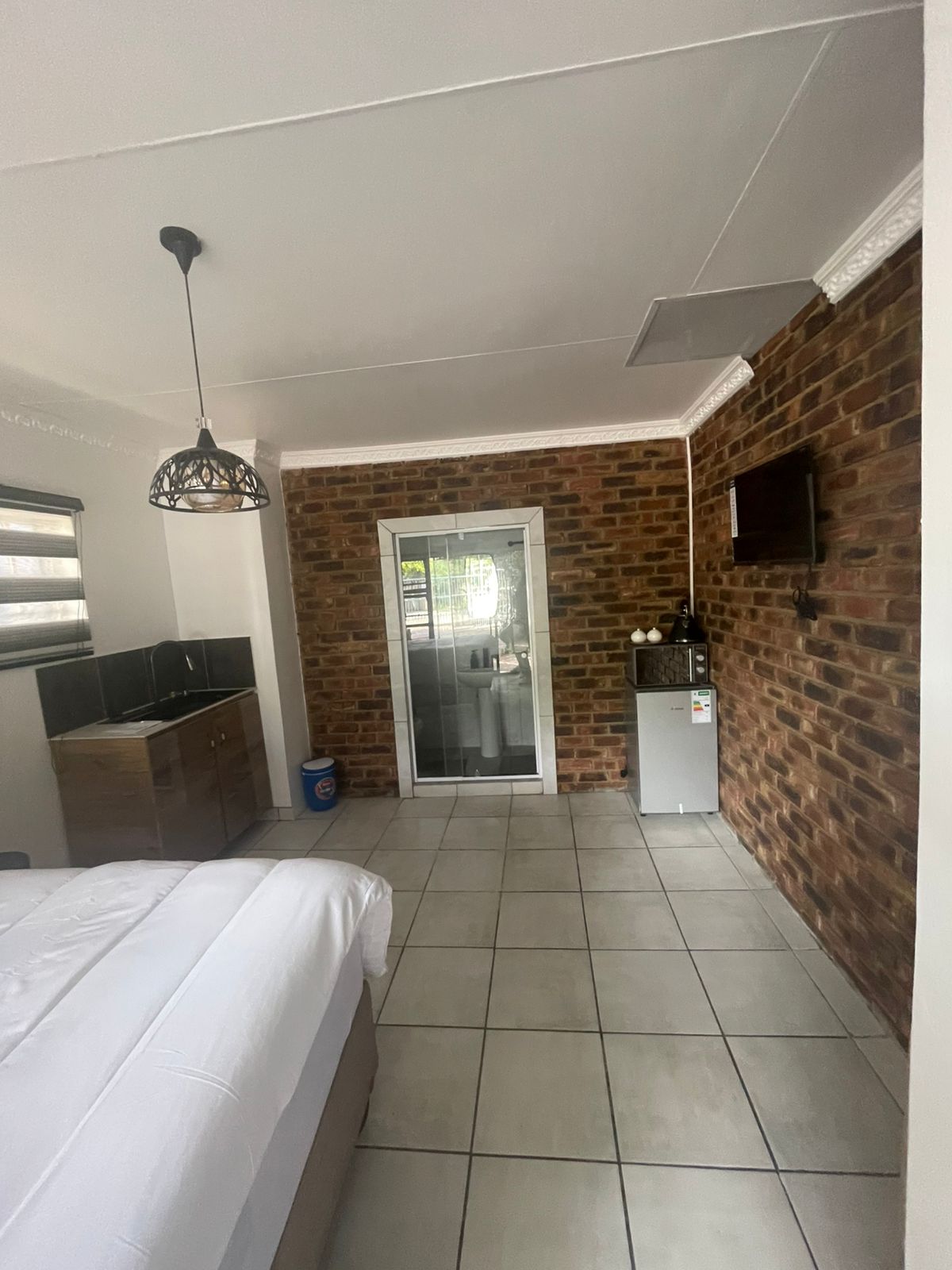 Smart TV mounted on brick feature wall